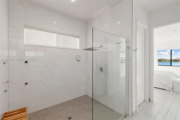 a bathroom with a shower and a glass door
