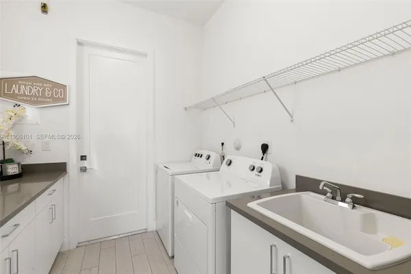 a spacious bathroom with a granite countertop sink and a mirror