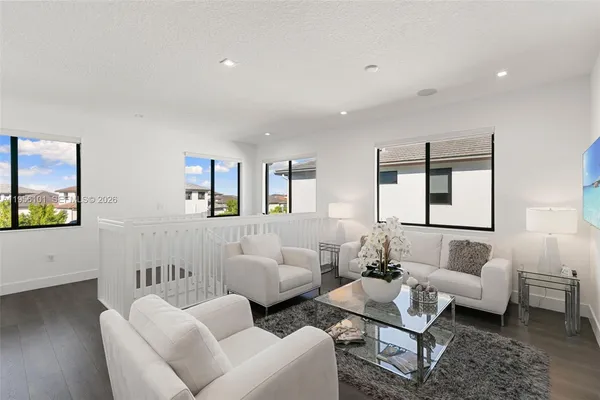 a living room with furniture and painting on the wall