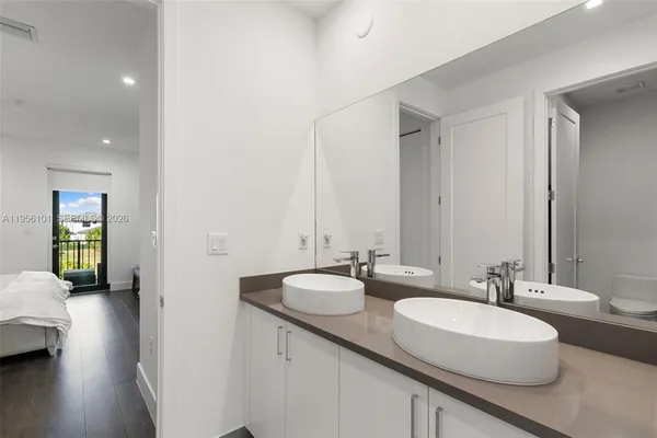 a bathroom with a double vanity sink and mirror