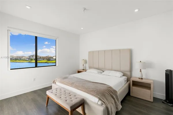 a bedroom with a bed and a painting on the wall