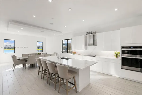 a large kitchen with a table and chairs