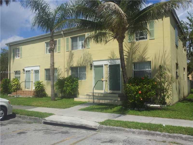 457 Northwest 84th Street, Unit 457 Miami, FL 33150 - Photo 4 of 4 front view of a house with a yard