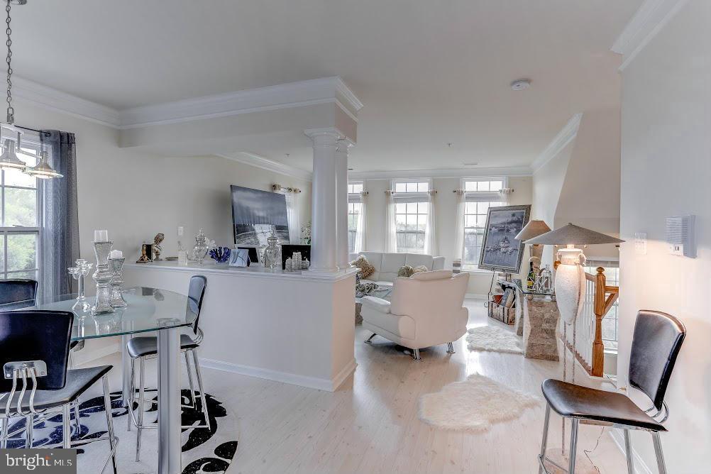 1838 B Monocacy View Circle, Unit 55B Frederick, MD 21701 - Photo 11 of 28 a living room with furniture and a dining table with kitchen appliances
