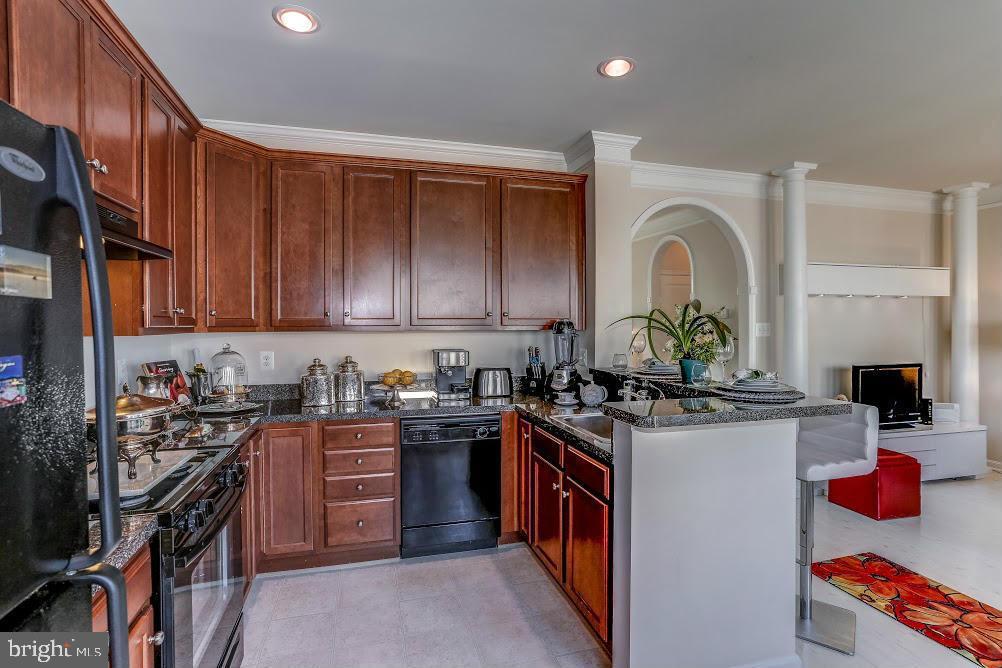 1838 B Monocacy View Circle, Unit 55B Frederick, MD 21701 - Photo 22 of 28 a kitchen with stainless steel appliances granite countertop a stove top oven a sink dishwasher and cabinets with wooden floor