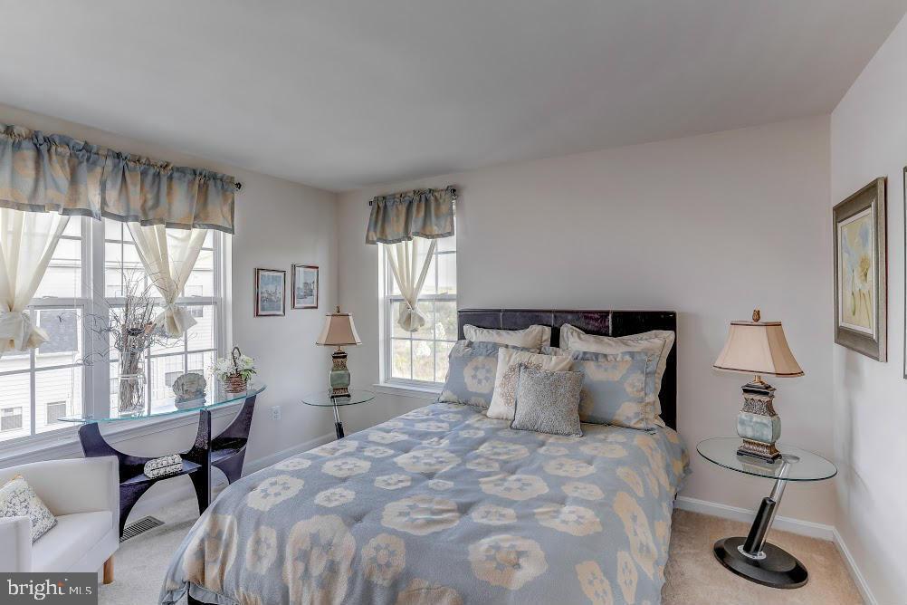 1838 B Monocacy View Circle, Unit 55B Frederick, MD 21701 - Photo 26 of 28 a bedroom with a bed a table and windows