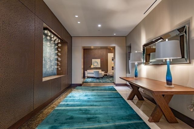 a view of a kitchen with kitchen island a large window a sink and a refrigerator