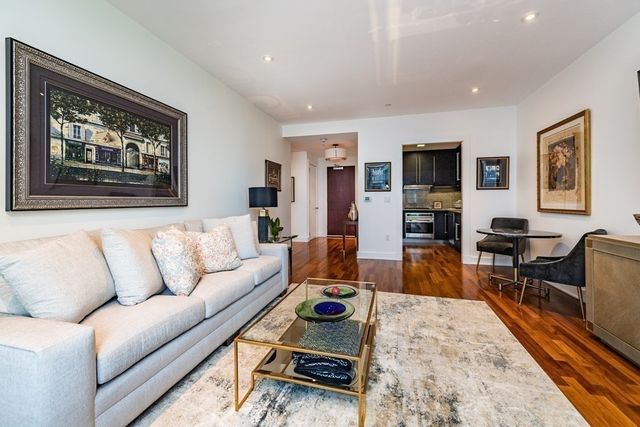 a living room with furniture a rug and a flat screen tv
