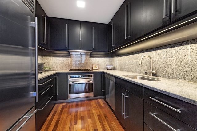 a kitchen with granite countertop stainless steel appliances and cabinets