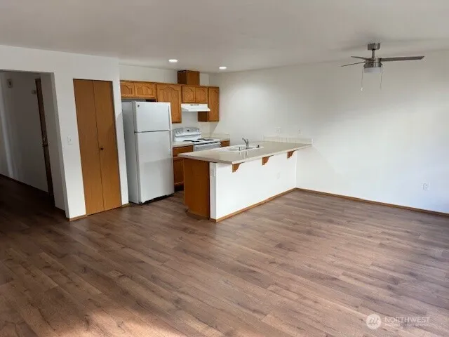 a kitchen with granite countertop a refrigerator and a sink