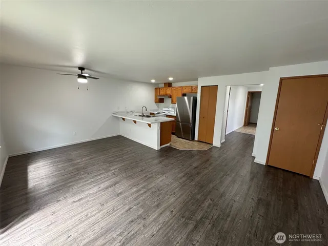 a view of a kitchen with a sink and a refrigerator