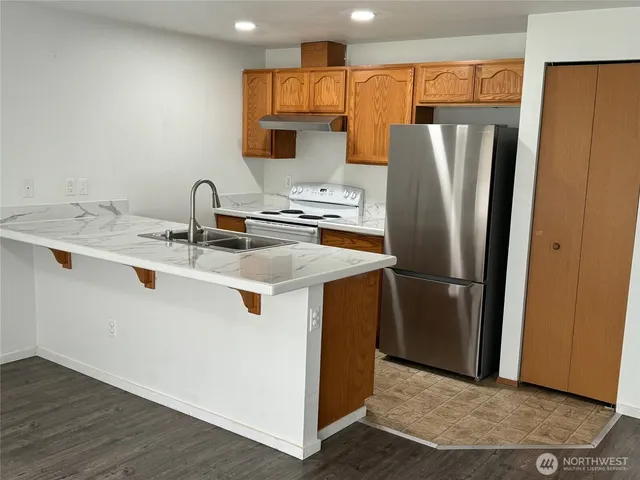 a kitchen with stainless steel appliances a refrigerator and a sink