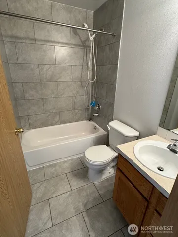 a bathroom with a toilet a sink and bathtub