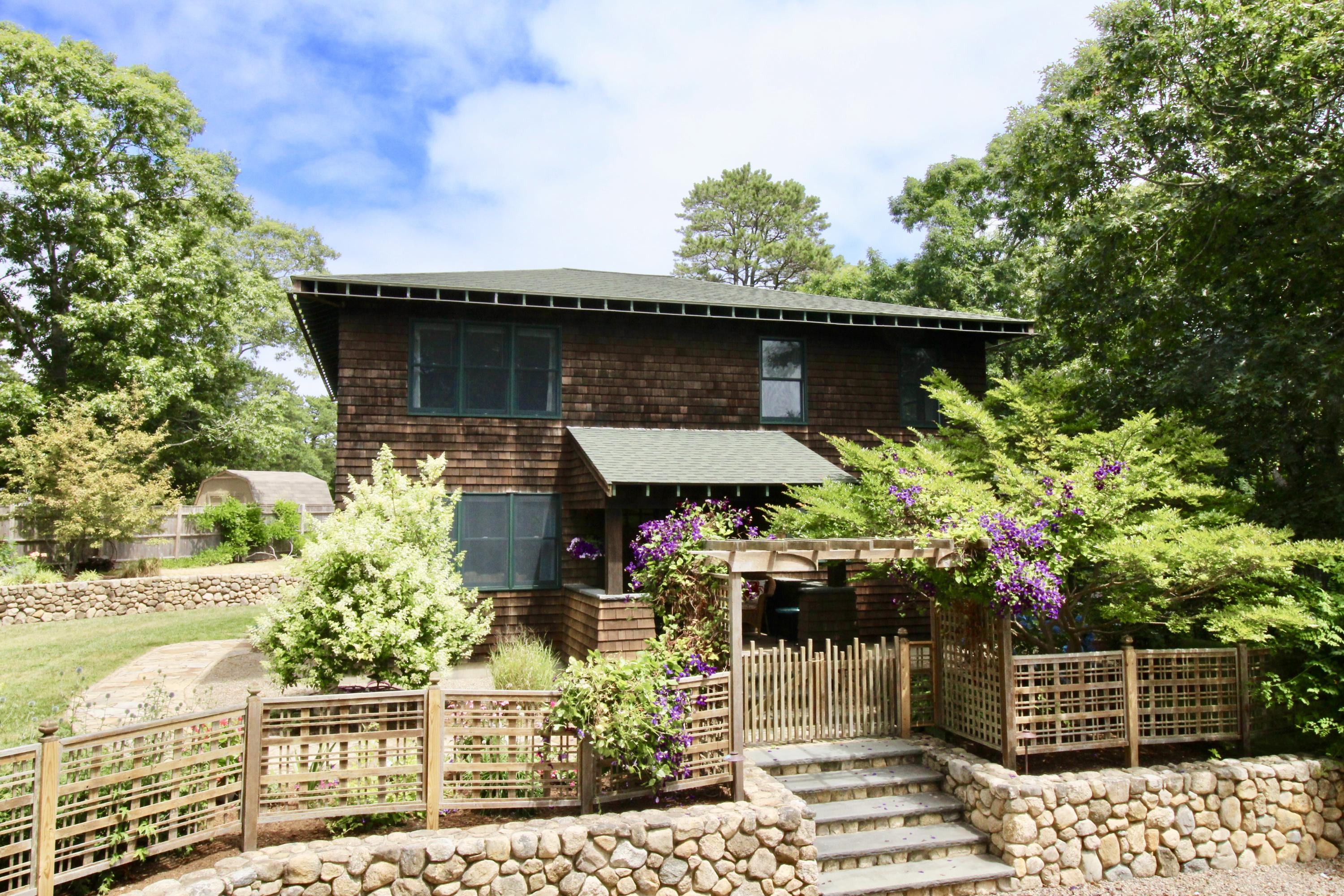 345 Blue Heron Road Wellfleet, MA 02667 - Photo 1 of 27 a front view of a house with a garden