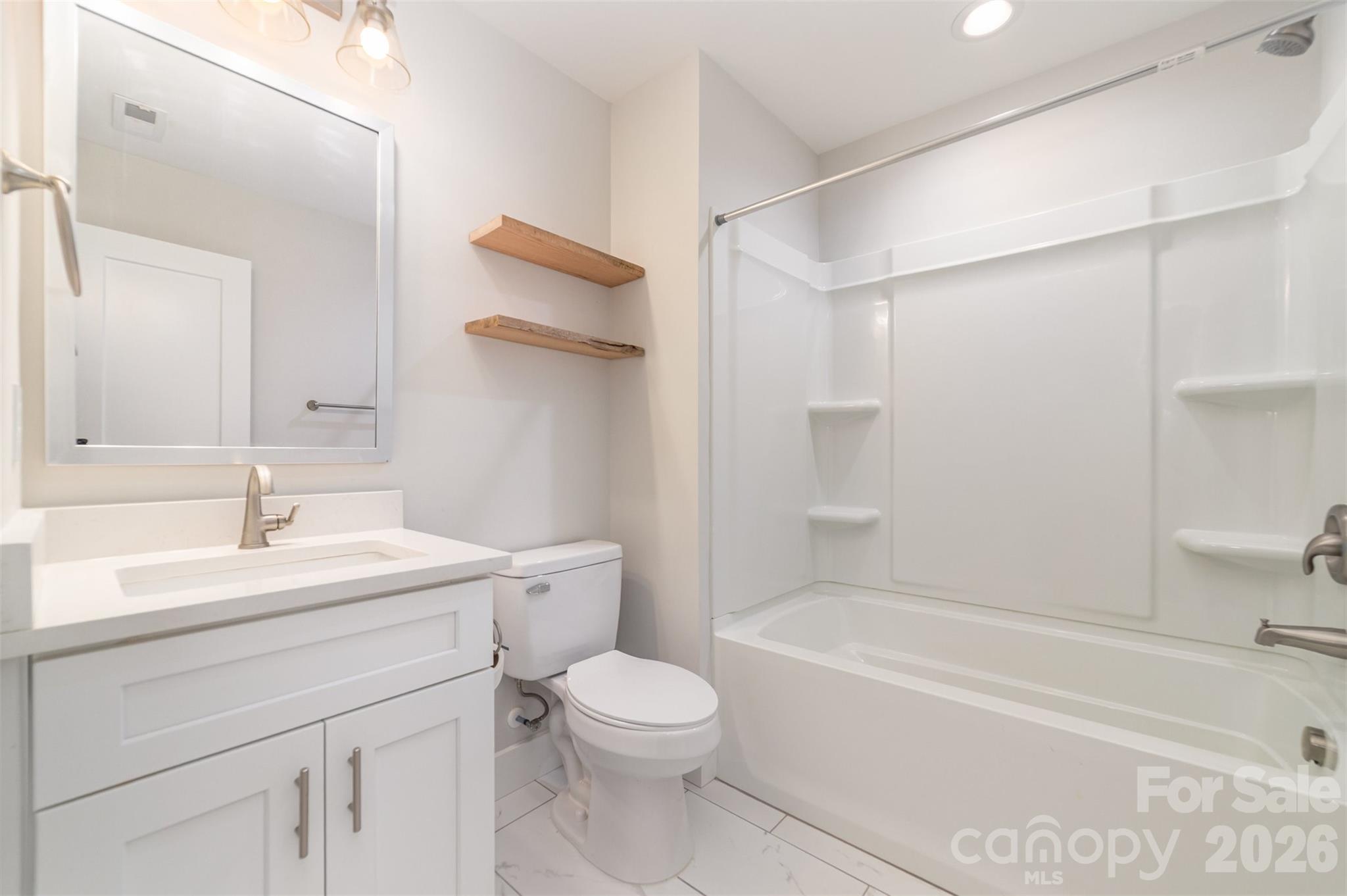 1003 Hunter Valley Road Shelby, NC 28150 - Photo 15 of 23 a bathroom with a sink a toilet and a bathtub