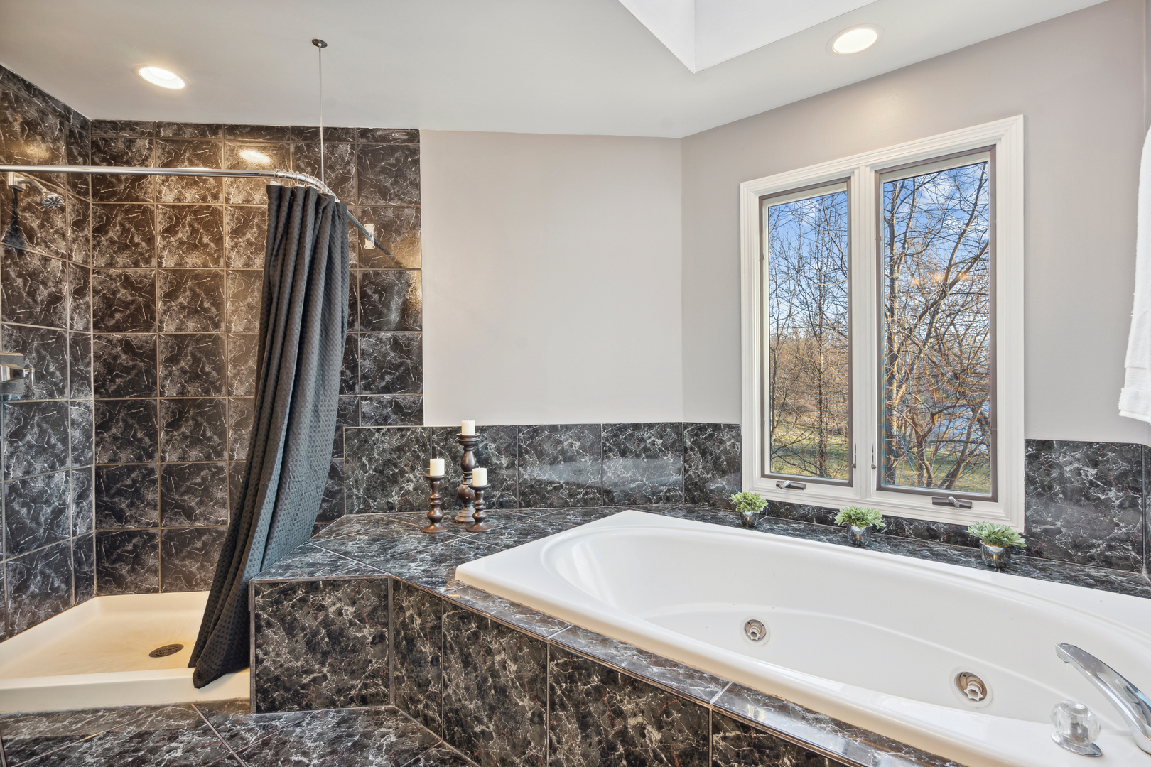14N682 Timber Ridge Drive Elgin, IL 60124 - Photo 10 of 26 a bathroom with a bathtub and a shower