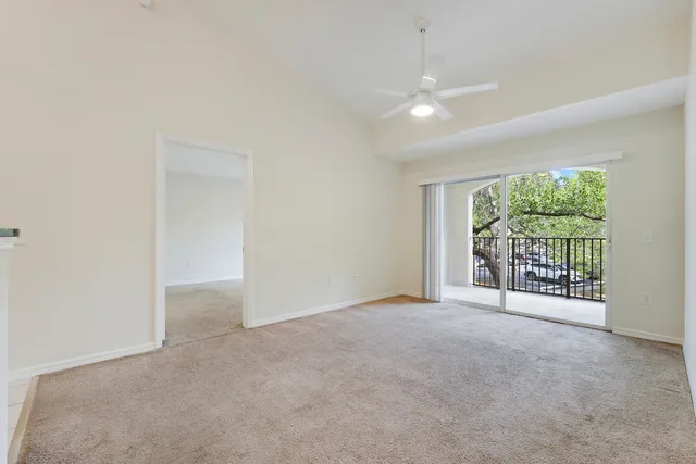 a view of a kitchen with a sink and a refrigerator