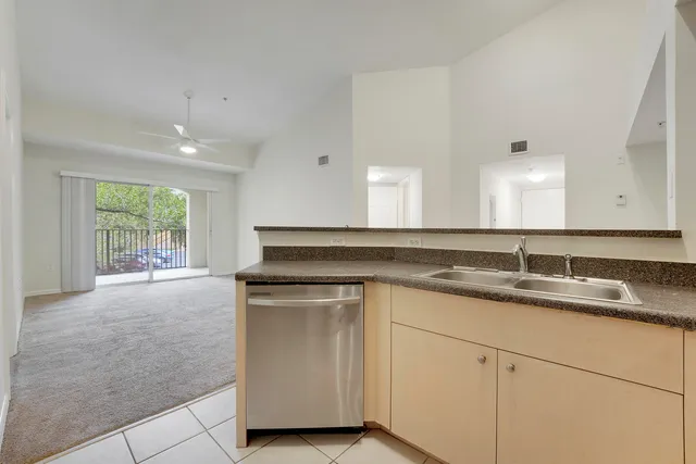 a kitchen with cabinets stainless steel appliances and a sink