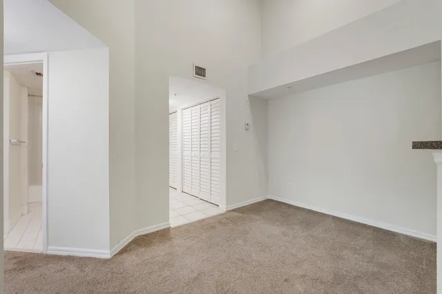 a view of an empty room with glass door