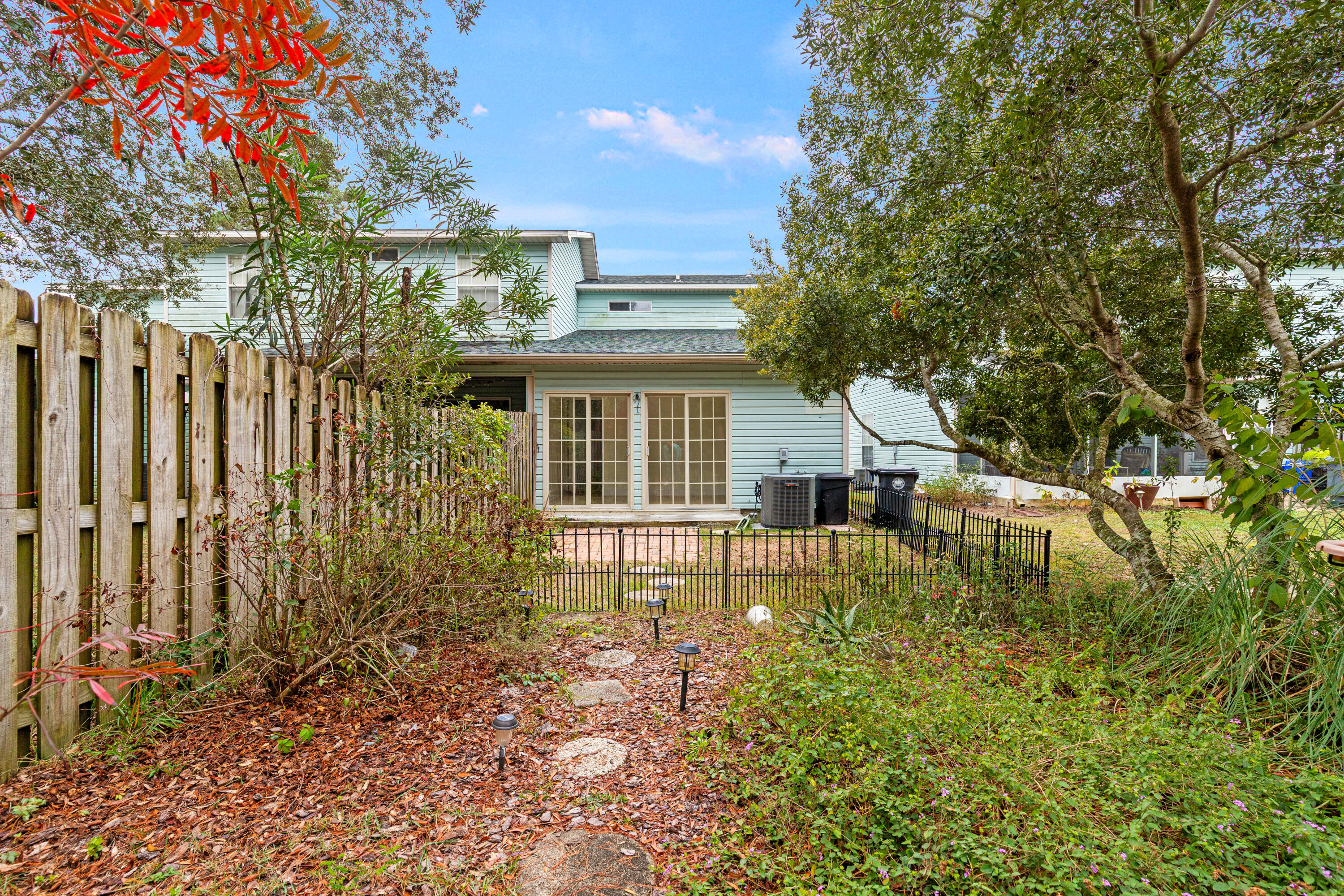 162 Vía Largo, Unit 22B Santa Rosa Beach, FL 32459 - Photo 26 of 26 a view of house with backyard and a garden