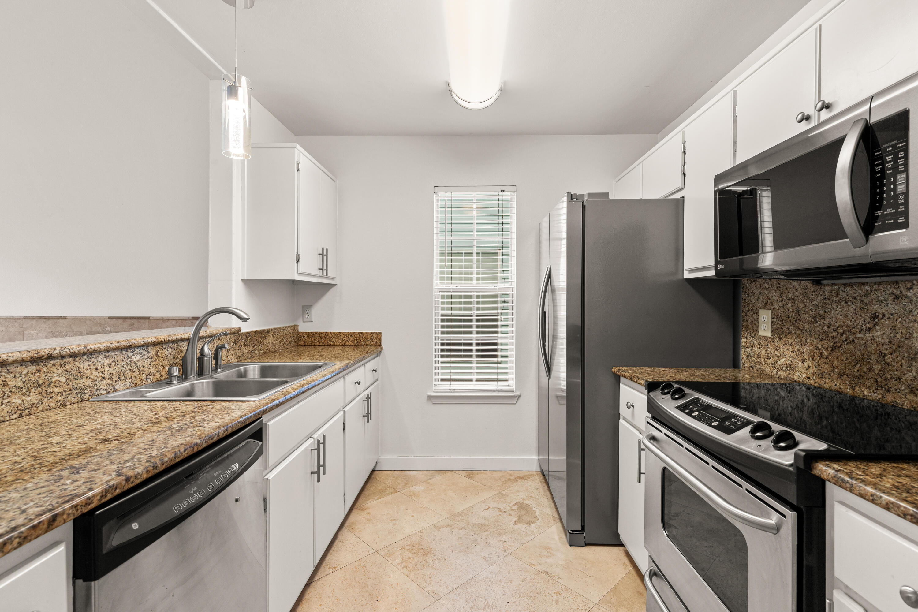 162 Vía Largo, Unit 22B Santa Rosa Beach, FL 32459 - Photo 6 of 26 a kitchen with a sink stove and microwave