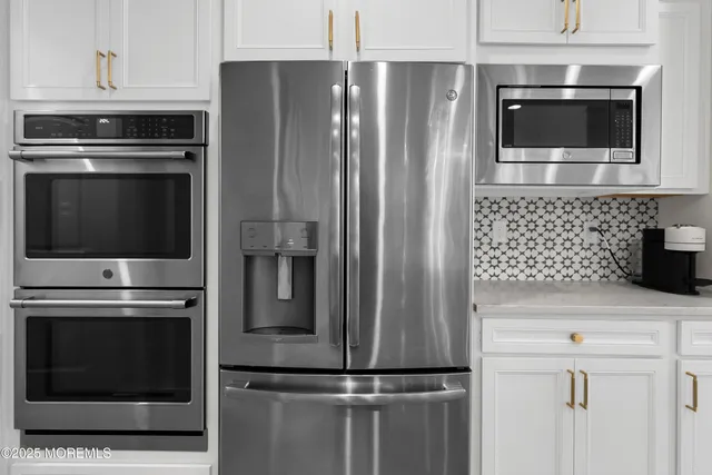 a kitchen with cabinets and stainless steel appliances
