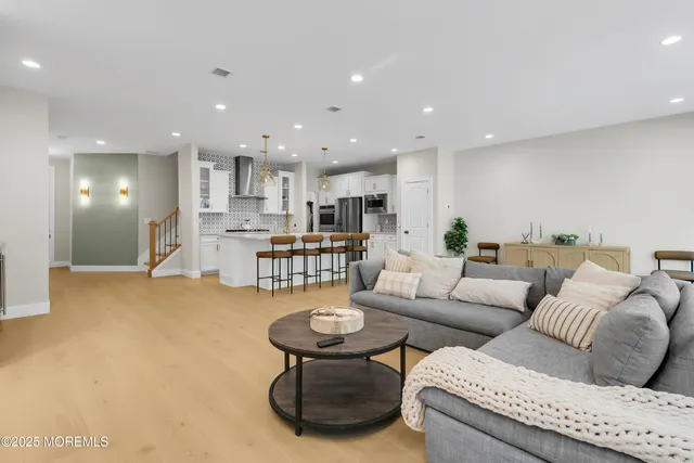 a living room with furniture and kitchen view