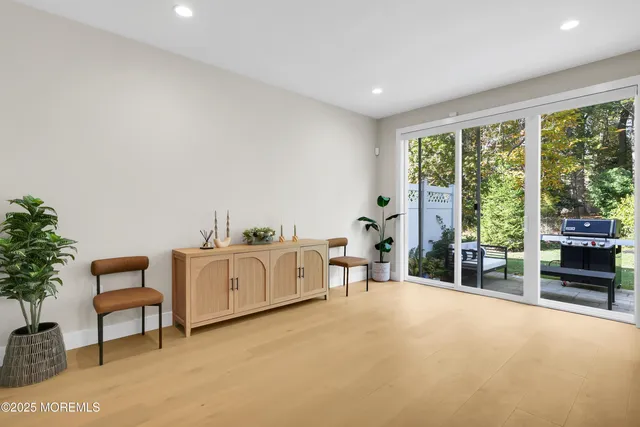 a living room with furniture a bed and a large window