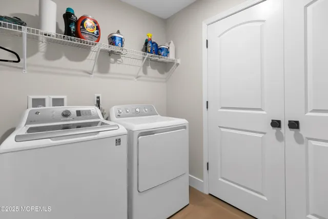 a view of storage and utility room with washer and dryer