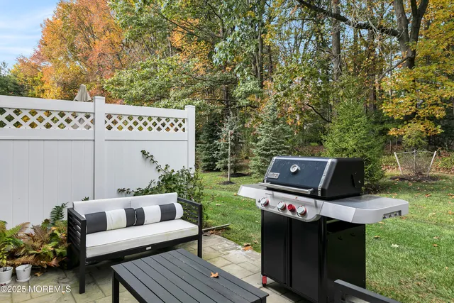 a view of a chairs and table in a backyard