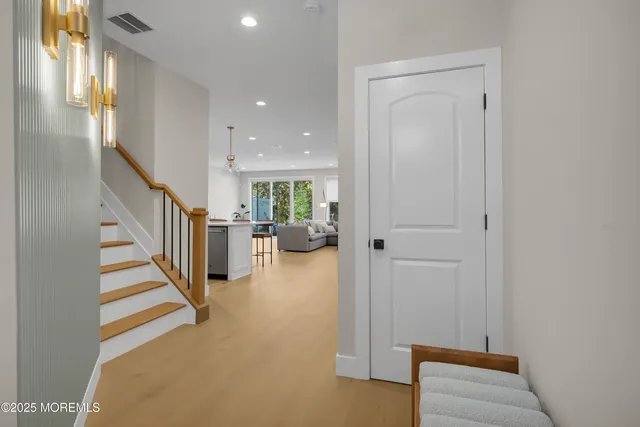 a view of entryway and hall with wooden floor