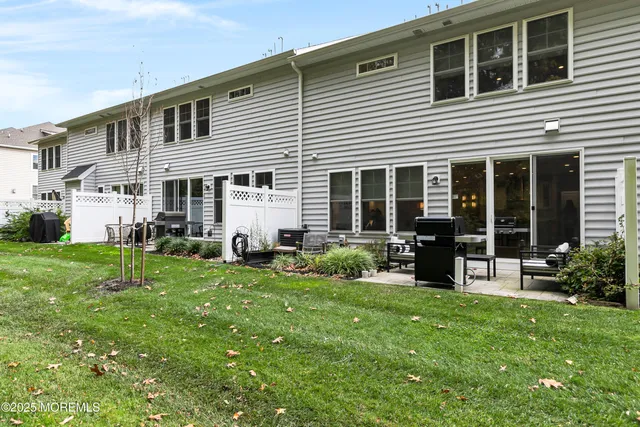 a front view of a house with a yard and chairs