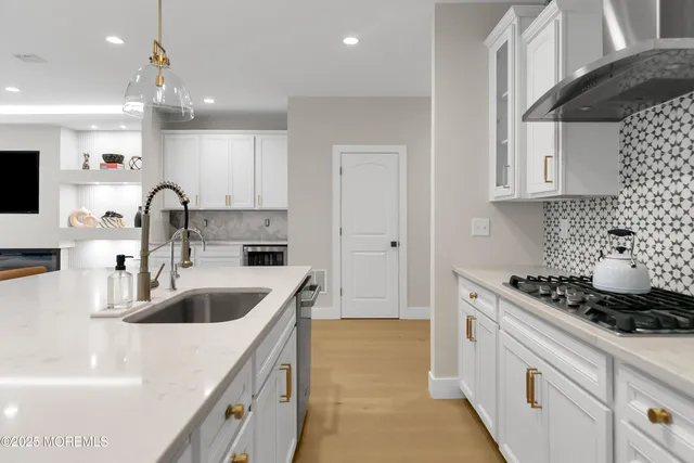 a kitchen with a sink cabinets and appliances