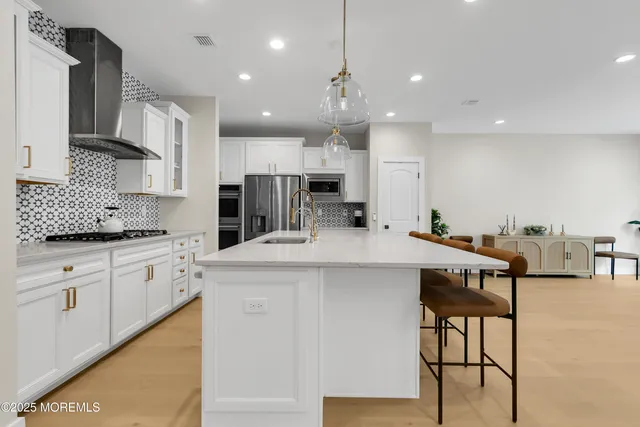 a kitchen with kitchen island granite countertop wooden cabinets and white appliances