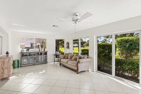a living room with furniture and large windows