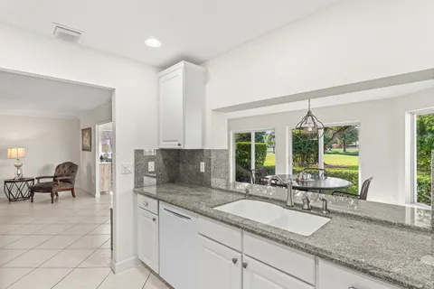 a kitchen with granite countertop a sink and a counter top space