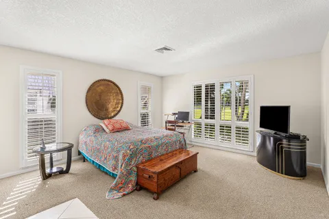 a bed room with a bed and a television