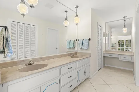 a bathroom with a granite countertop sink mirror and double
