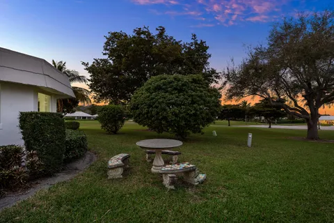 a view of a garden with a house in the background