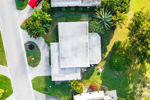 an aerial view of residential houses with outdoor space and swimming pool