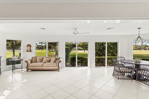 a living room with furniture and large windows