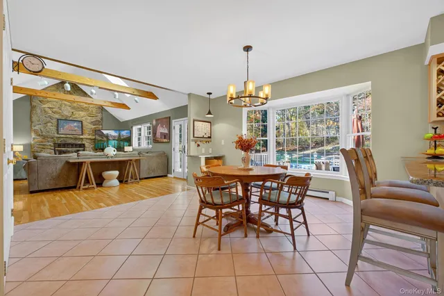 a view of a dining room with furniture and a chandelier