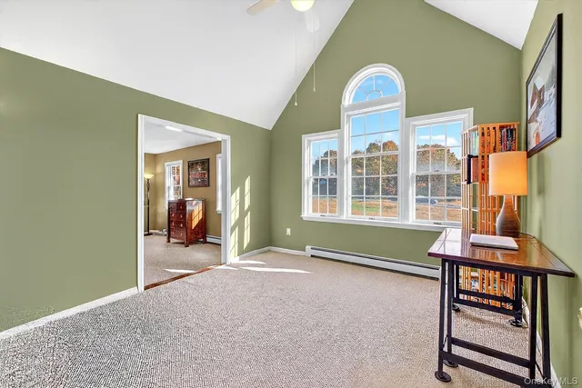 a view of a livingroom with furniture and a window