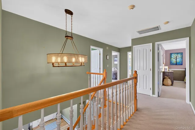 a view of a hallway with a chandelier