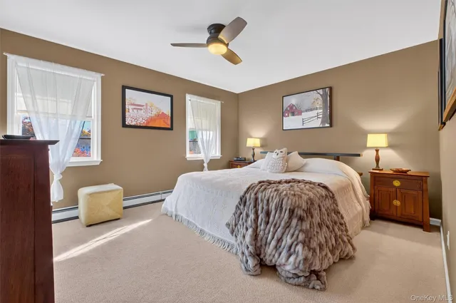 a spacious bedroom with a bed and a chandelier