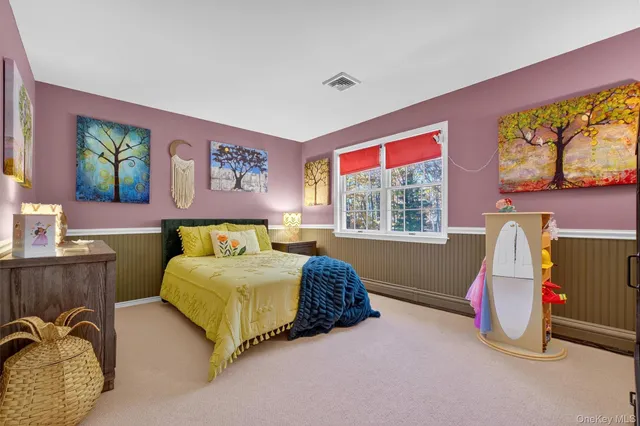 a bedroom with a bed and dresser