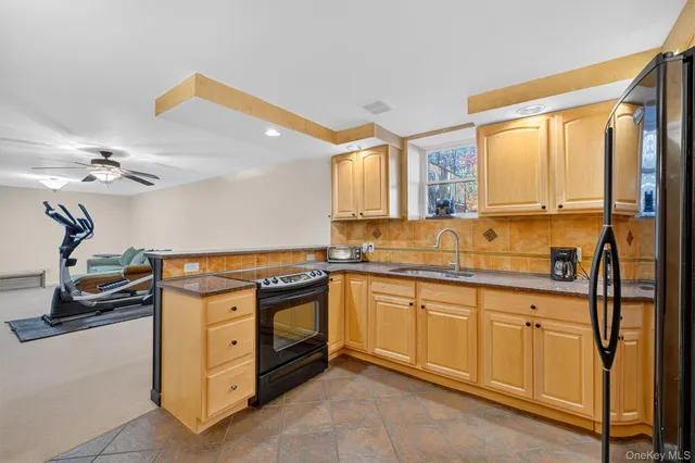 a kitchen with stainless steel appliances granite countertop a sink a stove and a refrigerator