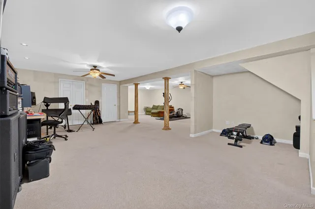 a view of the livingroom with furniture and a gym machine