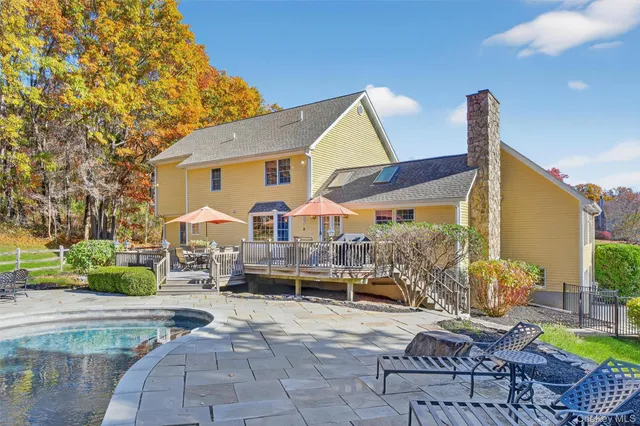 a view of a patio with couches table and chairs and potted plants