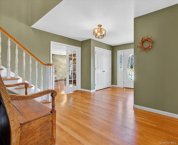 a view of an entryway with wooden floor